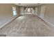 Vast bonus room with neutral carpet, dormer window, and multiple entryways for versatile use at 7214 Bedrock Cir, Lithonia, GA 30038