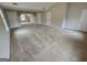 Large bonus room with neutral carpet, multiple windows, and doorways for flexible living space at 7214 Bedrock Cir, Lithonia, GA 30038