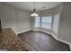 Open dining space with gray wood floors, modern lighting, and bay window for natural light at 7214 Bedrock Cir, Lithonia, GA 30038
