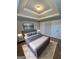 This main bedroom features a trey ceiling, plush carpeting, and a ceiling fan at 7214 Bedrock Cir, Lithonia, GA 30038