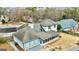 An aerial view of the home showcasing the backyard, screened porch and neighborhood at 103 Sandtrap Rdg, Peachtree City, GA 30269