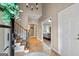 Bright entryway with staircase, tile flooring, and views to the living room at 103 Sandtrap Rdg, Peachtree City, GA 30269