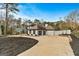 Two-story house with a gray roof, white exterior, and a large driveway at 103 Sandtrap Rdg, Peachtree City, GA 30269