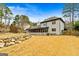 Back of house, showcasing a screened porch and landscaping, near a pool at 103 Sandtrap Rdg, Peachtree City, GA 30269