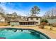 Home exterior with pool and a screened-in porch in the backyard at 103 Sandtrap Rdg, Peachtree City, GA 30269