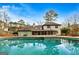Home exterior featuring a pool, screened porch, and landscaped backyard at 103 Sandtrap Rdg, Peachtree City, GA 30269