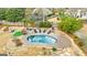 An inviting kidney-shaped pool with surrounding patio and landscaping at 103 Sandtrap Rdg, Peachtree City, GA 30269
