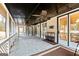 Spacious screened porch with ceiling fan and stone tile floor at 103 Sandtrap Rdg, Peachtree City, GA 30269
