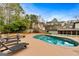 Inviting kidney-shaped pool with surrounding lounge chairs at 103 Sandtrap Rdg, Peachtree City, GA 30269