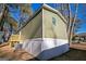 Side view of the mobile home showcasing its green siding and deck at 1979 Cardell Rd # 20, Austell, GA 30168