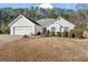 Charming one-story home with white exterior, attached garage, and landscaped front yard at 212 Spivey Ridge Cir, Lake Spivey, GA 30236