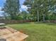 Expansive, fully fenced backyard showcasing lush lawn and mature trees, perfect for outdoor activities and relaxation at 2110 Kellington Dr, Mcdonough, GA 30253