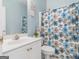 Bathroom features a blue and white floral shower curtain and white vanity at 2110 Kellington Dr, Mcdonough, GA 30253