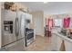 Well-equipped kitchen with stainless steel appliances, white cabinetry, and a view of the adjacent dining area at 2110 Kellington Dr, Mcdonough, GA 30253