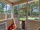 Enclosed screened porch with views of the fenced backyard and mature trees, offering a serene outdoor space at 2110 Kellington Dr, Mcdonough, GA 30253