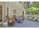 Outdoor deck with Adirondack chairs, wicker seating, umbrella for shade, and backyard views at 337 Legacy Ln, Peachtree City, GA 30269