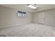 Unfinished basement space features neutral paint, carpeted floor and natural light from a window at 337 Legacy Ln, Peachtree City, GA 30269