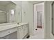 Bathroom featuring tile flooring, white cabinetry, a mirror and access to the shower at 337 Legacy Ln, Peachtree City, GA 30269