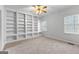 Neutral bedroom with carpeted floors, a ceiling fan, a window, and built-in bookshelves at 337 Legacy Ln, Peachtree City, GA 30269