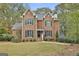 Charming brick two-story home featuring green shutters and a well-maintained front lawn at 337 Legacy Ln, Peachtree City, GA 30269