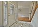 Bright foyer with marble tile, chandelier view into the dining room and wooden staircase at 337 Legacy Ln, Peachtree City, GA 30269
