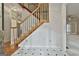 Foyer featuring a staircase with wooden banister and marble tile flooring with black accents at 337 Legacy Ln, Peachtree City, GA 30269