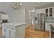 Spacious kitchen boasts stainless steel appliances and a white center island with granite countertops at 337 Legacy Ln, Peachtree City, GA 30269