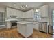 Bright kitchen features white cabinets, stainless steel appliances, and a center island with stone countertops at 337 Legacy Ln, Peachtree City, GA 30269
