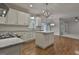 Open kitchen with white cabinets, subway tile backsplash, stainless steel appliances, and center island at 337 Legacy Ln, Peachtree City, GA 30269