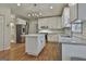 Modern kitchen with white cabinets, stainless steel appliances, and hardwood floors at 337 Legacy Ln, Peachtree City, GA 30269