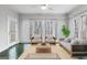 Bright sunroom with green-tiled floors, multiple windows, and neutral furniture and decor at 337 Legacy Ln, Peachtree City, GA 30269