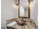 Stylish bathroom vanity with a copper bowl sink and granite countertop at 10195 Kinross Rd, Roswell, GA 30076