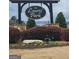 Laurel Park neighborhood sign surrounded by manicured shrubbery and flowers at 128 Lavender Way # 75, Mcdonough, GA 30252