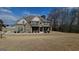 Beautiful two-story home featuring a well-manicured front yard and a charming covered porch entrance at 128 Lavender Way # 75, Mcdonough, GA 30252