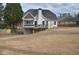 Expansive backyard features a deck, screened in porch, and mature trees providing a tranquil outdoor space at 205 Belvedere Green, Peachtree City, GA 30269