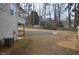 Expansive backyard featuring a retaining wall and fence, with ample space for recreation and landscaping at 205 Belvedere Green, Peachtree City, GA 30269