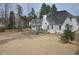 A spacious backyard featuring a wooden fence and mature trees, perfect for outdoor activities and privacy at 205 Belvedere Green, Peachtree City, GA 30269