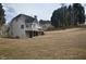 Spacious backyard with a deck, mature trees, and privacy fence, offering a serene outdoor retreat at 205 Belvedere Green, Peachtree City, GA 30269