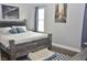 Cozy bedroom with a gray wood bed frame, soft blue pillows, and artwork at 205 Belvedere Green, Peachtree City, GA 30269
