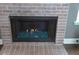 Close up of the fireplace with brick surround and glass accents at 205 Belvedere Green, Peachtree City, GA 30269