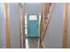 Foyer featuring wood floors, bright blue front door, and a staircase at 205 Belvedere Green, Peachtree City, GA 30269