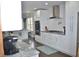 Bright kitchen features white cabinetry, stainless steel appliances, and granite countertops at 205 Belvedere Green, Peachtree City, GA 30269