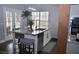 Kitchen island with bar stool seating, pendant lighting and stainless steel dishwasher at 205 Belvedere Green, Peachtree City, GA 30269