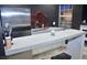 Stylish basement kitchenette with stainless steel refrigerator, white cabinets, and bar countertop at 205 Belvedere Green, Peachtree City, GA 30269