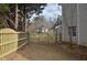 Side yard featuring a wooden fence, a gate, and green grass, offering security and privacy at 205 Belvedere Green, Peachtree City, GA 30269