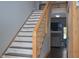 Wooden staircase with white risers leads into an open concept living space at 205 Belvedere Green, Peachtree City, GA 30269