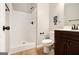 Bathroom featuring a standing shower, dark wood vanity, toilet, and humorous wall art at 1205 Heartwood Ave, Mcdonough, GA 30253