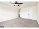 Carpeted bedroom with a ceiling fan and a closet, offering a comfortable and functional space at 1205 Heartwood Ave, Mcdonough, GA 30253