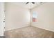 Bright bedroom featuring a ceiling fan, neutral carpet, and a window letting in natural light at 1205 Heartwood Ave, Mcdonough, GA 30253