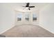 Spacious bedroom with neutral carpet, ceiling fan, and bright natural light from large windows at 1205 Heartwood Ave, Mcdonough, GA 30253